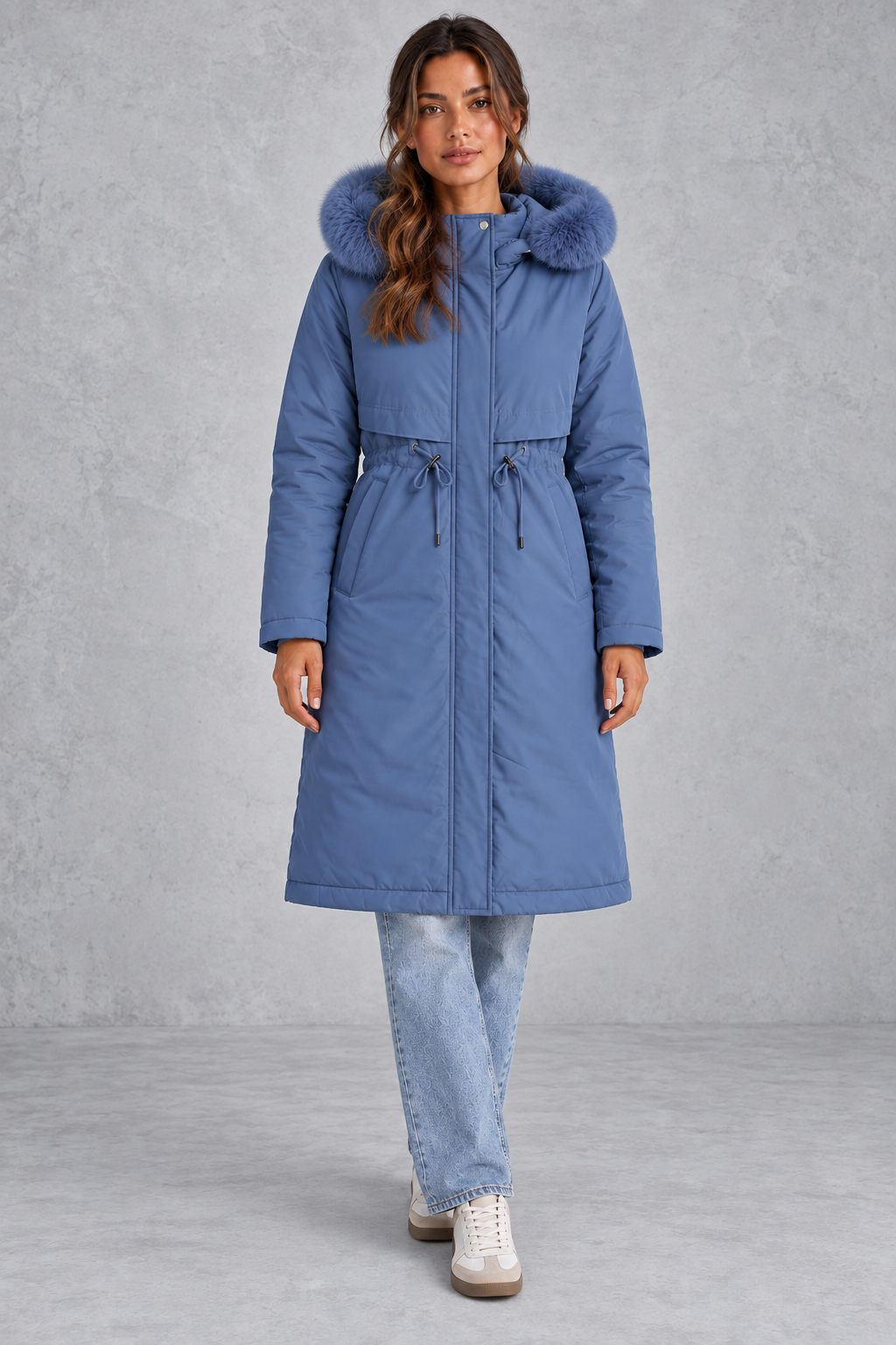 Women’s long hooded winter parka with faux fur trim, a plush-lined interior, adjustable drawstring waist and relaxed silhouette.