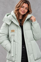 Women's long hooded puffer coat in Mint Green – close-up