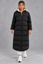 Women's long hooded puffer coat in Black – front view
