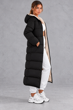 Women's long hooded puffer coat in Black – side view