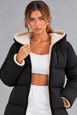 Women's long hooded puffer coat in Black – close-up