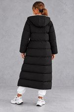 Women's long hooded puffer coat in Black – back view