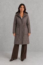 Women’s long quilted puffer coat with classic diamond quilting, a soft faux fur collar, adjustable drawstring waist and practical front pockets.