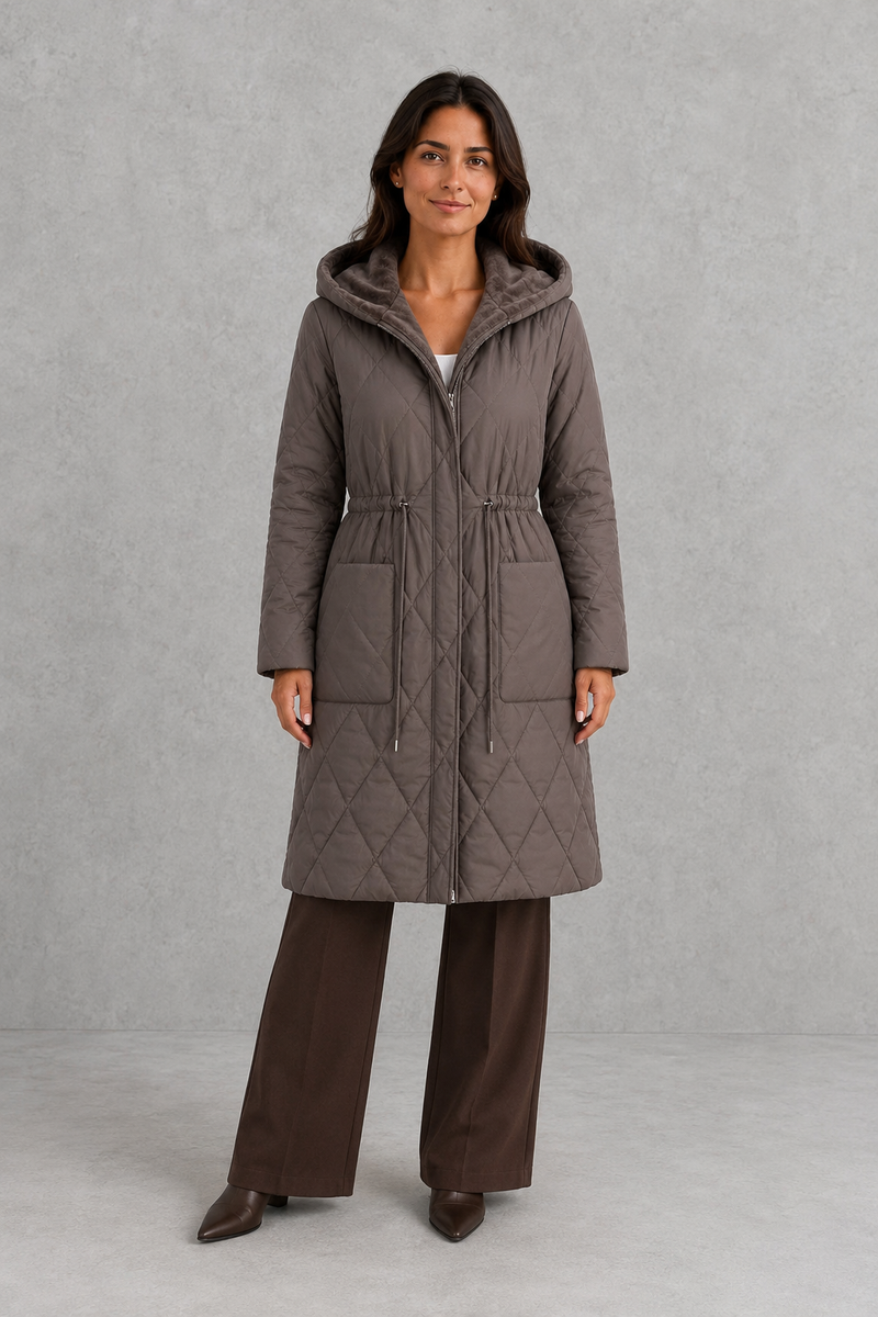 Women’s long quilted puffer coat with classic diamond quilting, a soft faux fur collar, adjustable drawstring waist and practical front pockets.