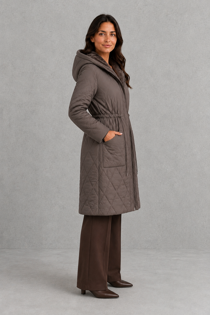 Women’s long quilted puffer coat with classic diamond quilting, a soft faux fur collar, adjustable drawstring waist and practical front pockets.