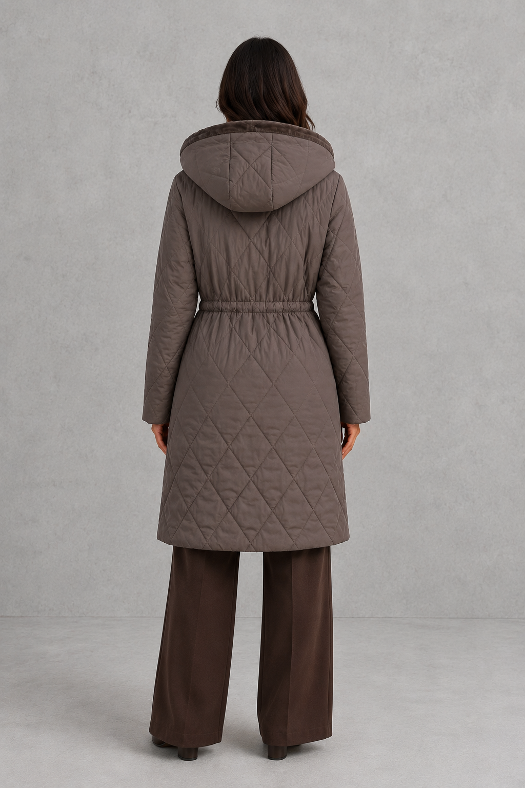 Women’s long quilted puffer coat with classic diamond quilting, a soft faux fur collar, adjustable drawstring waist and practical front pockets.
