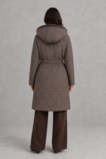 Women’s long quilted puffer coat with classic diamond quilting, a soft faux fur collar, adjustable drawstring waist and practical front pockets.