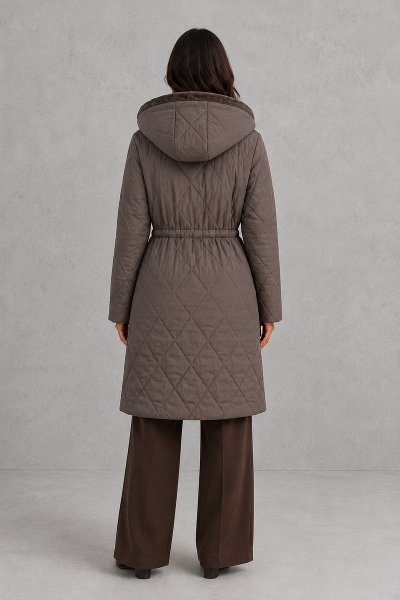 Women’s long quilted puffer coat with classic diamond quilting, a soft faux fur collar, adjustable drawstring waist and practical front pockets.