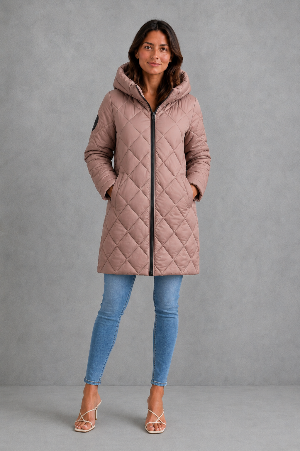 Women’s long quilted winter coat with lightweight thermal padding, protective hood, high collar and an elegant longline silhouette.