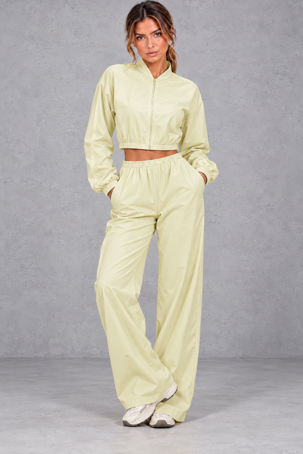 Women's yellow cropped zip-up jacket and wide leg trouser fitness set – front view