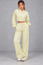 Women's yellow cropped zip-up jacket and wide leg trouser fitness set – front view