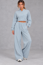 Women's sky blue cropped zip-up jacket and wide leg trouser fitness set – front view