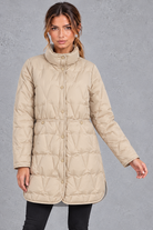 Women's longline quilted down coat in Beige – front view