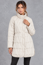 Women's longline quilted down coat in White – front view