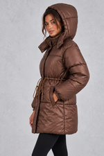 Women’s longline hooded puffer coat with quilted padding, a high neckline, adjustable drawstring waist and practical side pockets.