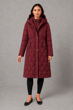 Women’s longline hooded puffer coat with insulated padding, waterproof and windproof protection, practical pockets and extended winter coverage.
