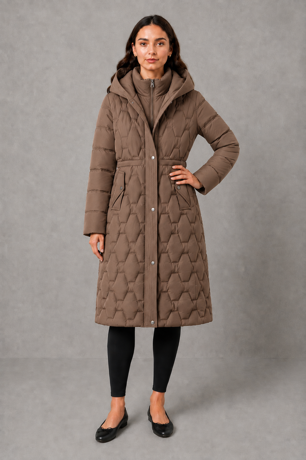 Women’s longline hooded puffer coat with insulated padding, waterproof and windproof protection, practical pockets and extended winter coverage.