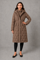 Women’s longline hooded puffer coat with insulated padding, waterproof and windproof protection, practical pockets and extended winter coverage.