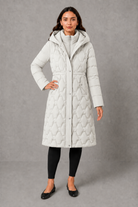 Women’s longline hooded puffer coat with insulated padding, waterproof and windproof protection, practical pockets and extended winter coverage.