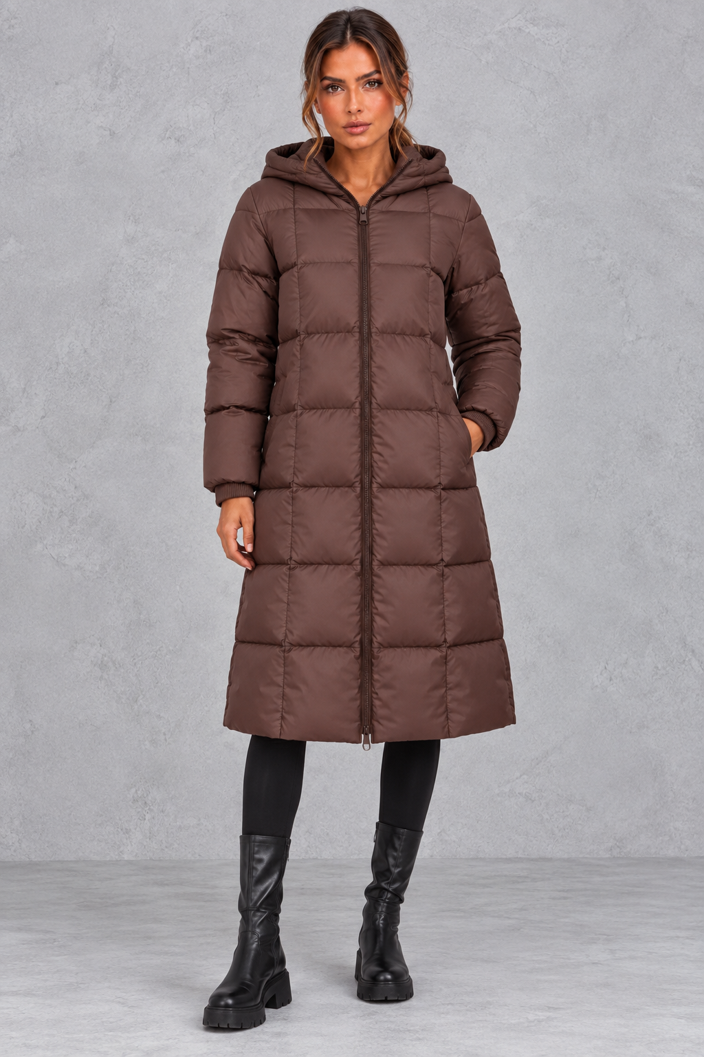 Women’s longline hooded puffer winter coat with streamlined quilting, a high neckline, full zip front and practical side pockets.