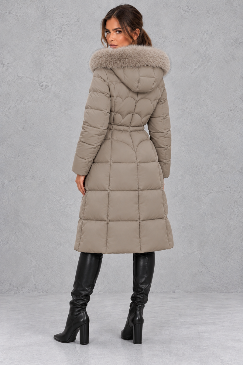 Women’s longline quilted puffer coat with a detachable faux fur hood, adjustable drawstring waist and warm padded construction.