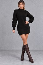 Women's black knit jumper mini dress with fluffy banded long sleeves and high neck – front view