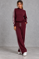 Women's burgundy mock neck wide leg tracksuit set with side stripes – front view