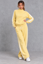 Women's yellow mock neck wide leg tracksuit set with side stripes – front view