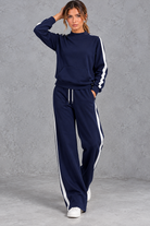 Women's navy blue mock neck wide leg tracksuit set with side stripes – front view