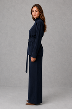 Women’s navy pinstripe two piece set with belted high neck long-sleeve top and matching wide leg palazzo trousers.