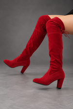 Women's over-the-knee boots in Red – seated side view