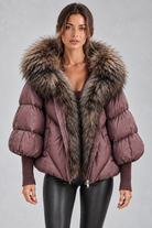 Women’s oversized puffer jacket with a plush faux fur-trimmed hood, voluminous padding, dropped shoulders and extended ribbed cuffs.