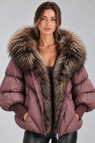 Women’s oversized puffer jacket with a plush faux fur-trimmed hood, voluminous padding, dropped shoulders and extended ribbed cuffs.