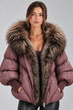 Women’s oversized puffer jacket with a plush faux fur-trimmed hood, voluminous padding, dropped shoulders and extended ribbed cuffs.
