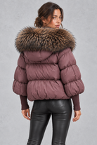 Women’s oversized puffer jacket with a plush faux fur-trimmed hood, voluminous padding, dropped shoulders and extended ribbed cuffs.