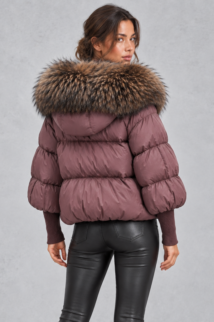 Women’s oversized puffer jacket with a plush faux fur-trimmed hood, voluminous padding, dropped shoulders and extended ribbed cuffs.