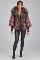 Women’s oversized puffer jacket with a plush faux fur-trimmed hood, voluminous padding, dropped shoulders and extended ribbed cuffs.