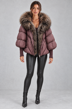 Women’s oversized puffer jacket with a plush faux fur-trimmed hood, voluminous padding, dropped shoulders and extended ribbed cuffs.