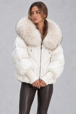 Women’s oversized puffer jacket with a plush faux fur-trimmed hood, voluminous padding, dropped shoulders and extended ribbed cuffs.