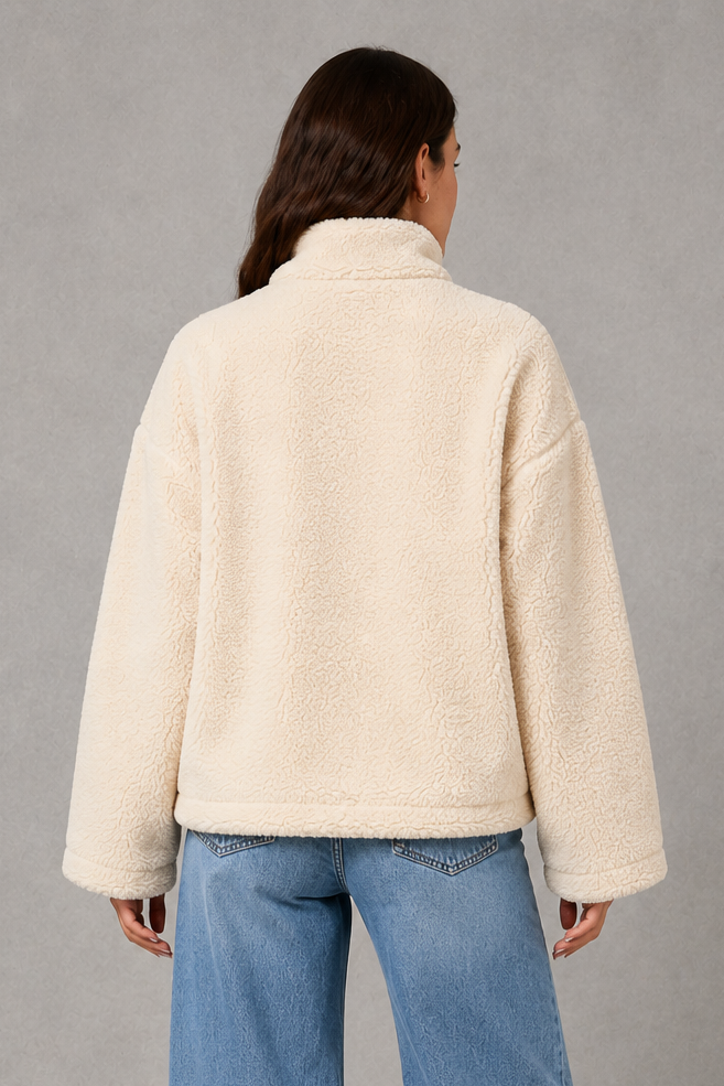 Women’s oversized teddy fleece jacket with a soft plush texture, full zip fastening, relaxed fit and practical front pockets.