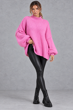 Women's pink oversized balloon sleeve jumper with leather-look leggings and boots – full-length view