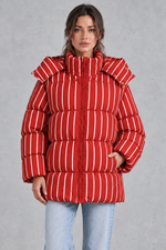Women’s pink and white striped oversized hooded puffer jacket with horizontal quilting, a high stand collar and voluminous padded silhouette.