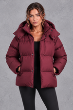 Women's oversized hooded puffer jacket in Wine Red – front view