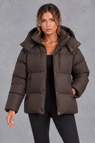 Women's oversized hooded puffer jacket in Brown – front view