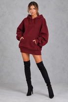 Women's burgundy oversized hoodie mini dress with drawstring hood and kangaroo pocket – front view