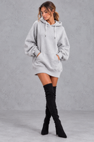 Women's grey oversized hoodie mini dress with drawstring hood and kangaroo pocket – front view