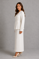 Women’s two piece tailored suit with a fitted V-neck peplum jacket, voluminous long sleeves and coordinating maxi pencil skirt for an elegant silhouette.