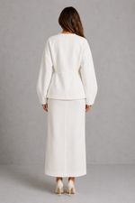 Women’s two piece tailored suit with a fitted V-neck peplum jacket, voluminous long sleeves and coordinating maxi pencil skirt for an elegant silhouette.