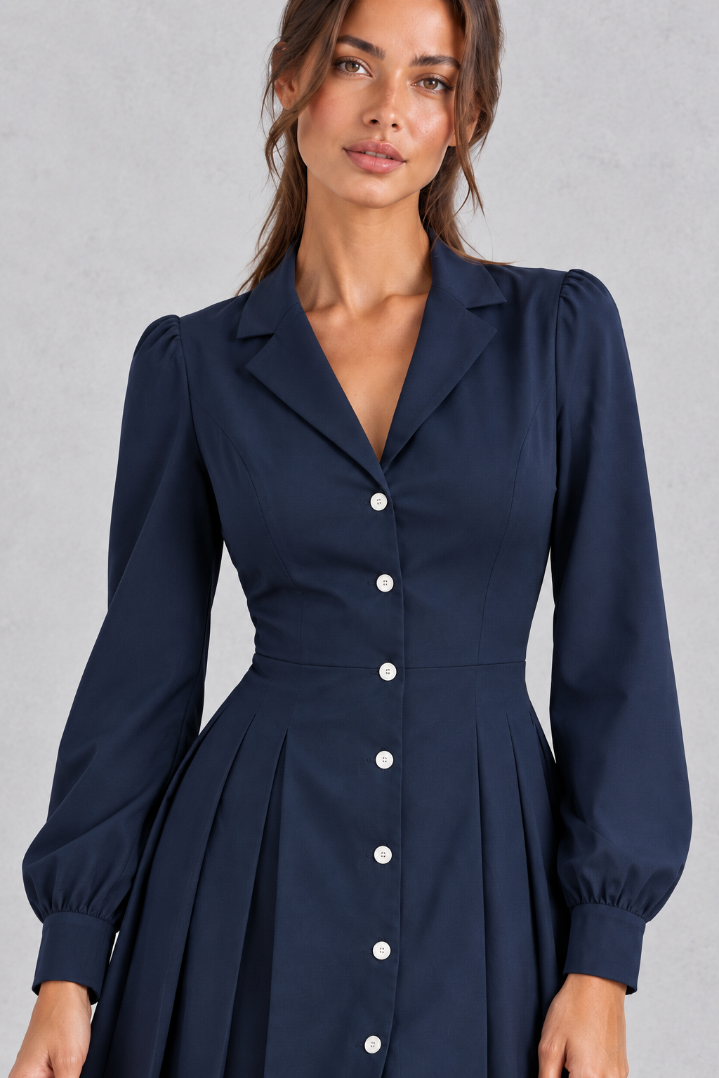 Women’s pleated shirt mini dress with long sleeves, a defined waist and tailored-inspired A-line silhouette.
