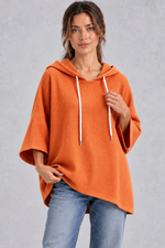 Women's plus size orange waffle knit oversized hoodie with drawstring hood and wide sleeves – front view